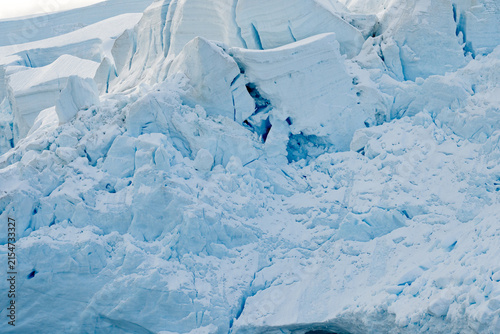 Large Glacial Crevasses on an Iceberg or Glacier Calving into the Ocean During an Antarctic Expedition