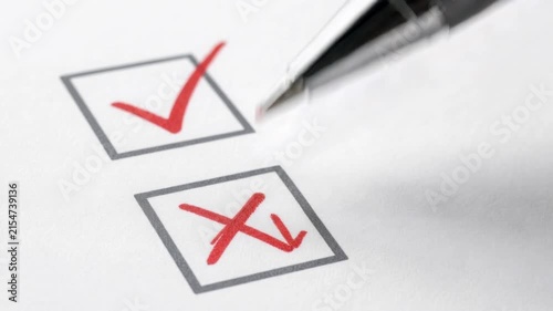 Close up of pen marking red cross and check marks on paper checklist for decision or survey concept