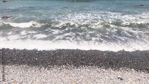 Ocean waves washing over a pebble beach