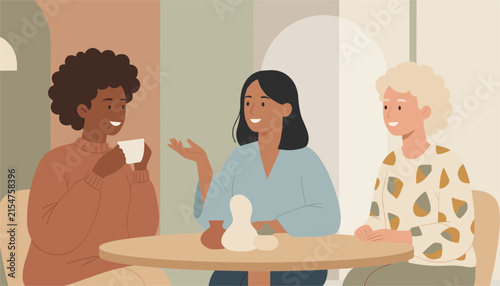 Diverse group of three women sitting around a table having a conversation and drinking coffee in a modern cafe environment.