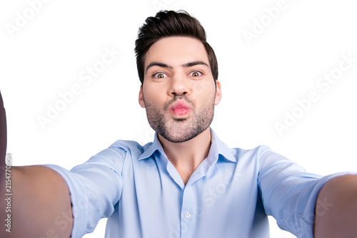 Obraz na plátně Self portrait of lovely stylish guy making self photo with two hands and sending
