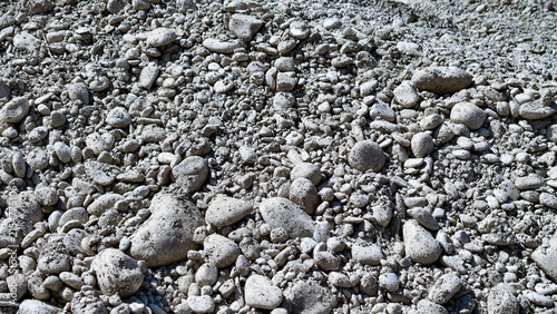 Obraz na płótnie Gravel background featuring a heap of light gray rocks and small pebbles, showca
