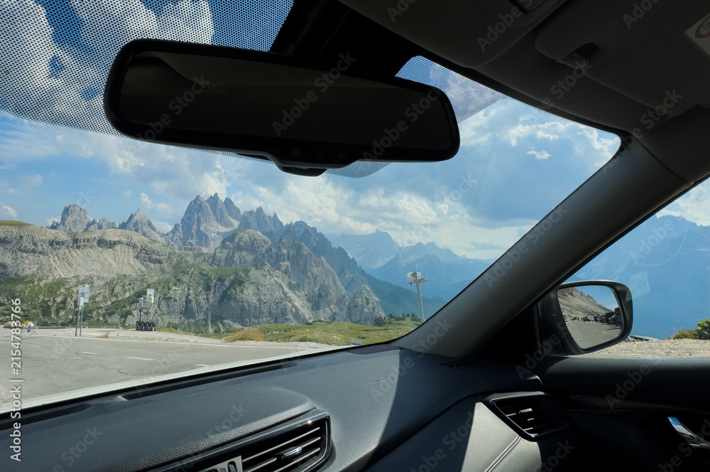 Fototapeta premium Mountains mirror on a road at sunset, concept of travel, journey, and looking back at the past. 