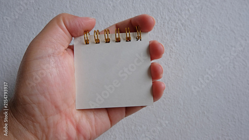 Hand holding blank paper. Mockup, Copy Space.