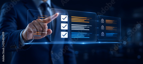 Businessman Touching Digital Checklist Screen with Security Lock Icons for Compliance Audit