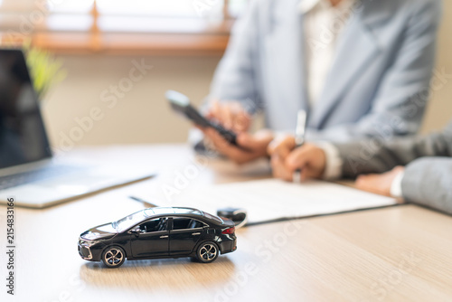 Business transport car and sell service concept, sales calculate sell price or rent of car for customer before sign on vehicle paperwork document contract with buyer woman client transfer automobile.