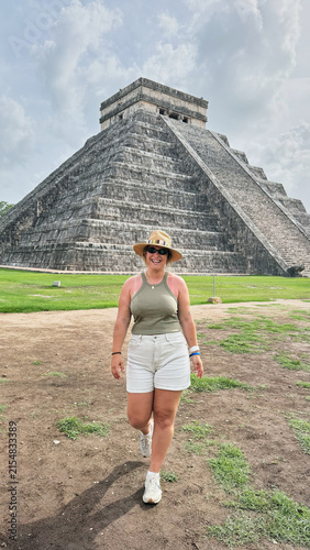 Woman traveling and exploring ancient Chichen Itza pyramid in Mexico