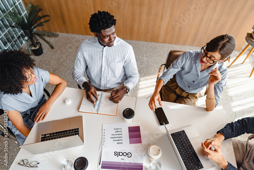 Team Members Discuss Ideas Around a Conference Table During Meeting
