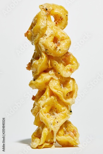 Creamy Tortellini Close Up Stack on White Background