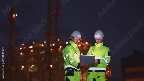 Engineers’ night shift working oil and gas refinery service, Workers hard work at night petroleum industry plant background, Oil and Gas Petrochemical industry.