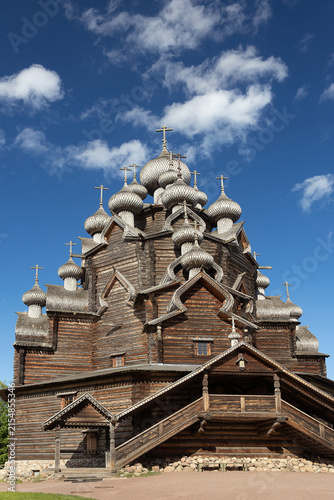 Traditional Russian multi domed wooden church under blue sky