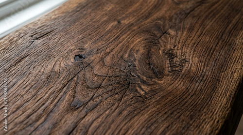 Close-up textured dark wood grain, rough natural surface, weathered oak plank background