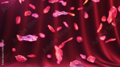 Abstract CGI of floating red fragments falling in front of a textured red curtain