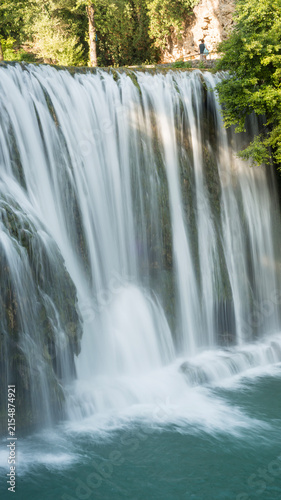 Pliva Waterfall in Jajce, Bosnia and Herzegovina surrounded by lush green forest