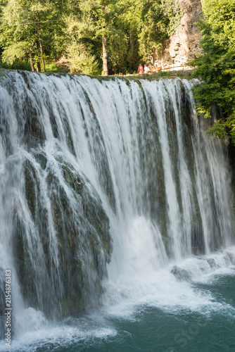Pliva Waterfall in Jajce, Bosnia and Herzegovina surrounded by lush green forest