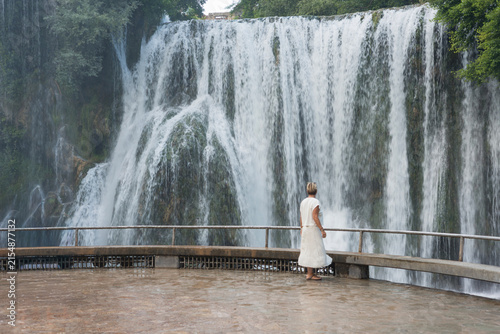 Pliva Waterfall in Jajce, Bosnia and Herzegovina surrounded by lush green forest