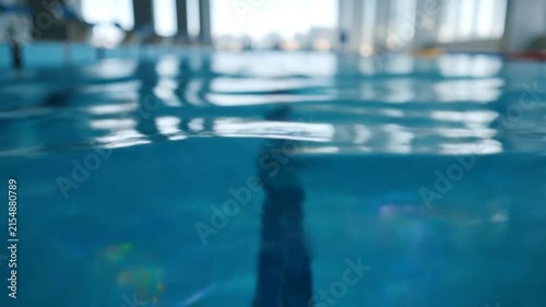 Underwater Perspective of Swimming Pool Water with Ripples and Reflections in an Indoor Environment