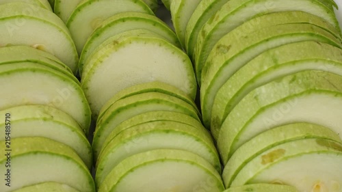 Green zucchini. Sliced raw zucchini close up, rotate