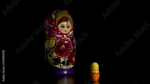 Spinning Matryoshka dolls on black background