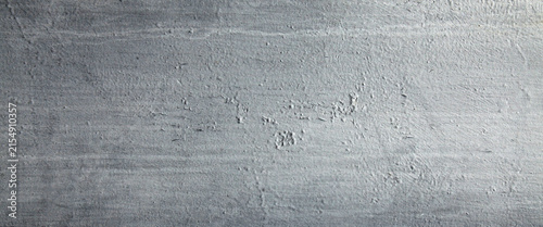 Metallic wall background, texture. Grey or dark-gray roughly painted surface. Old and faded wall and fence sketches. Dark, dingy and gloomy colors. Careless and poor painting