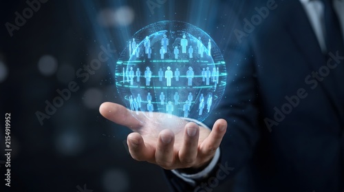 A businessman holding a glowing blue digital globe populated with human figure icons.