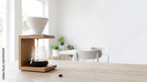 Coffee brewing setup with a white cup and wooden stand in a modern kitchen  