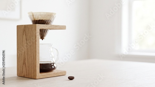 Wooden coffee dripper with glass pot and coffee bean on table  