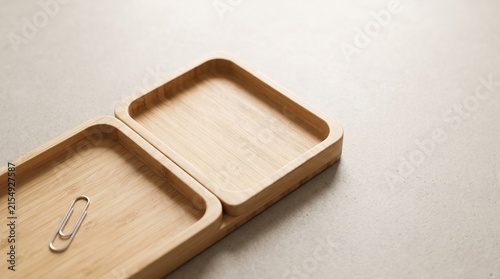 Bamboo trays with paperclip on a smooth surface  