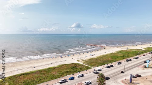 Aerial view of Galveston Island coastal town in Texas and Historic Pleasure Pier amusement park on ocean shoreline on a Sunny Day