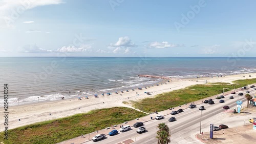 Aerial view of Galveston Island coastal town in Texas and Historic Pleasure Pier amusement park on ocean shoreline on a Sunny Day