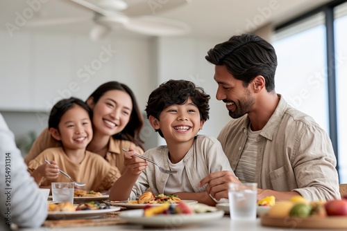 Happy family having breakfast together at home with joyful smiling kids