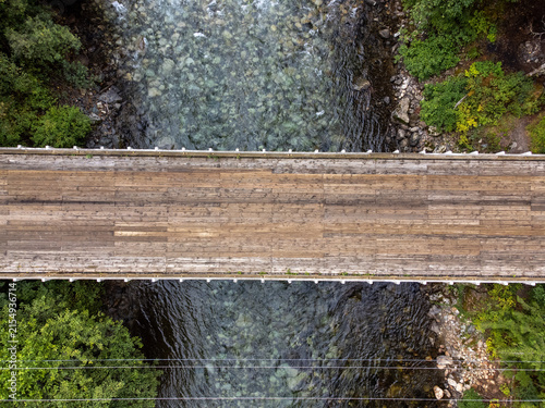 Wooden bridge over a river in a pine forest