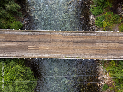 Wooden bridge over a river in a pine forest