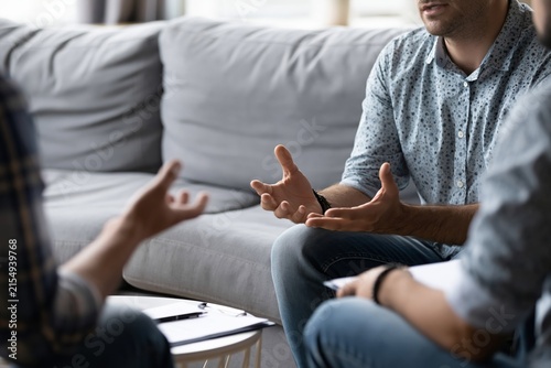 Clinical Psychologist Conducts Cognitive Behavioral Therapy Session in Office Setting With Clients