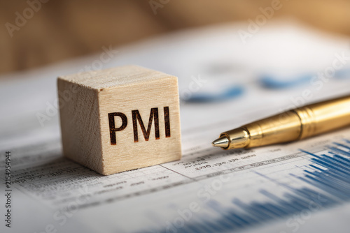 Text PMI on wood cube and gold pen lay on chart candle document paper , economic data concept