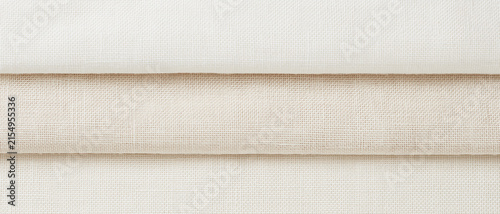 Minimalist linen fabric texture in ivory and off-white, soft neutral canvas backdrop with copy space