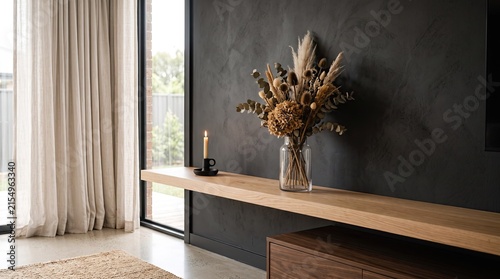 Modern minimalist living room interior featuring a rustic wooden console table with dried flower bouquet and dark textured wall