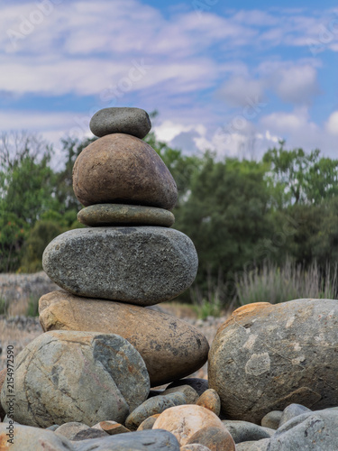 Canvas Print Balanced rock cairn standing outdoors under a cloudy sky