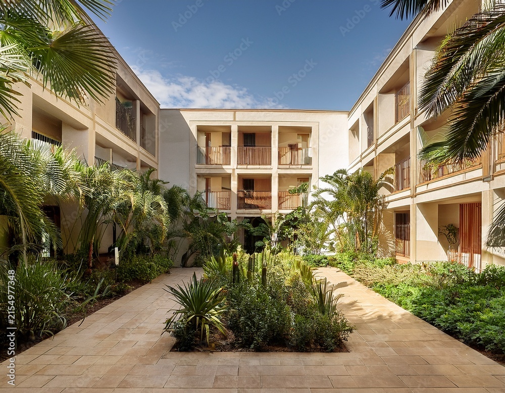 Fototapeta premium tropical courtyard garden with elegant building facade