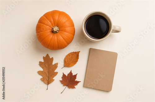 Autumn flat lay with pumpkin coffee cup leaves and blank notebook mockup