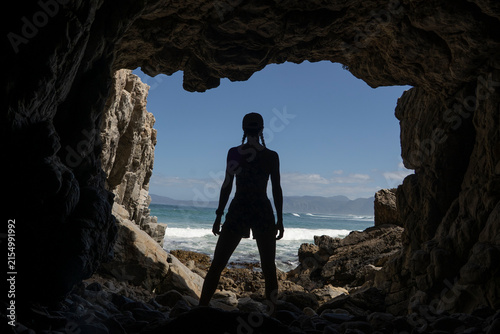 Silhouette of a person in Klipgat Caves in De Kelders along The Garden Route in South Africa.