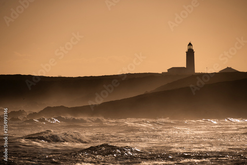 Danger Point Lighthouse in the sunset with a rough sea. De Kelders, The Garden Route, South Africa.