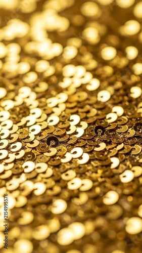 A shimmering surface of golden sequins reflecting soft light