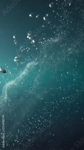 Air bubbles rising dynamically through deep blue underwater currents