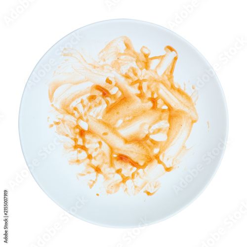 dirty red sauce on white circle plate isolated on white.