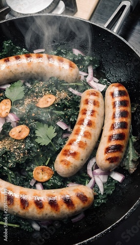 Sausages Cooking with Kale and Onions in Frying Pan