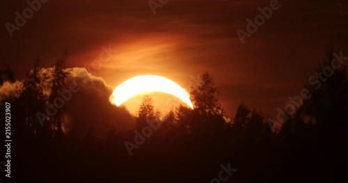 Partial Solar eclipse during a sunset on 12th of August 2026 behind a forest in rural Estonia, Northern Europe