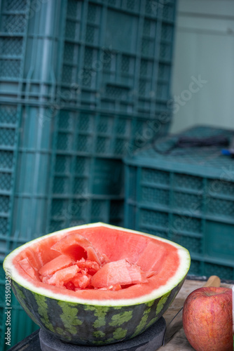 Obraz na plátne Fresh sliced watermelon prepared for tasting at local traditional market in South Korea with green plastic crates background