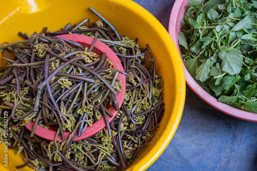 Fotografie Boiled gosari bracken fern and green wild vegetables in plastic basins at traditional market in South Korea