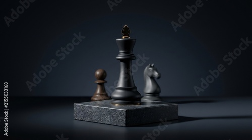 Black chess king with gold crown on stone pedestal with blurred chess pieces